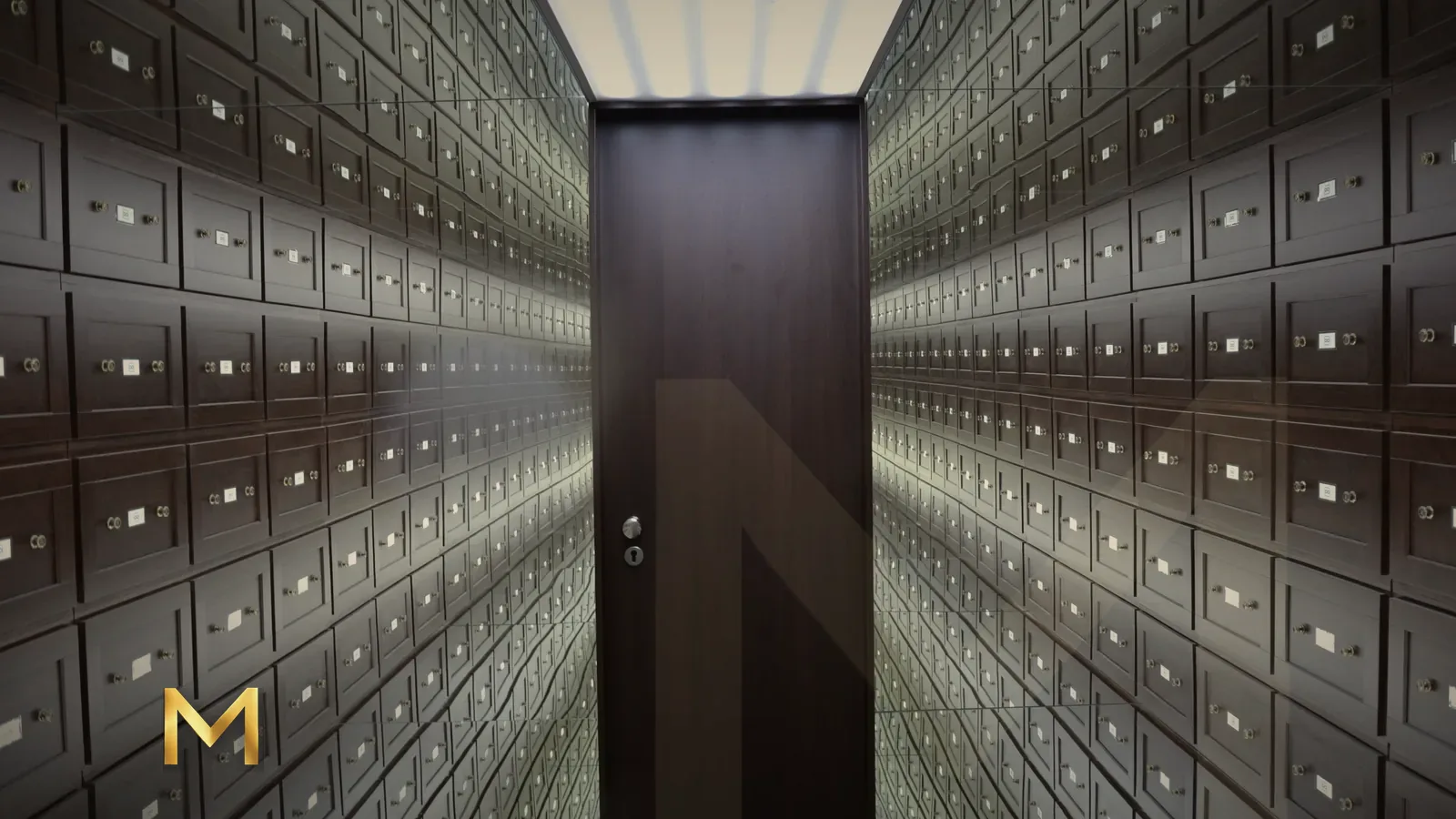 A long corridor of safe deposit boxes leading to a single door