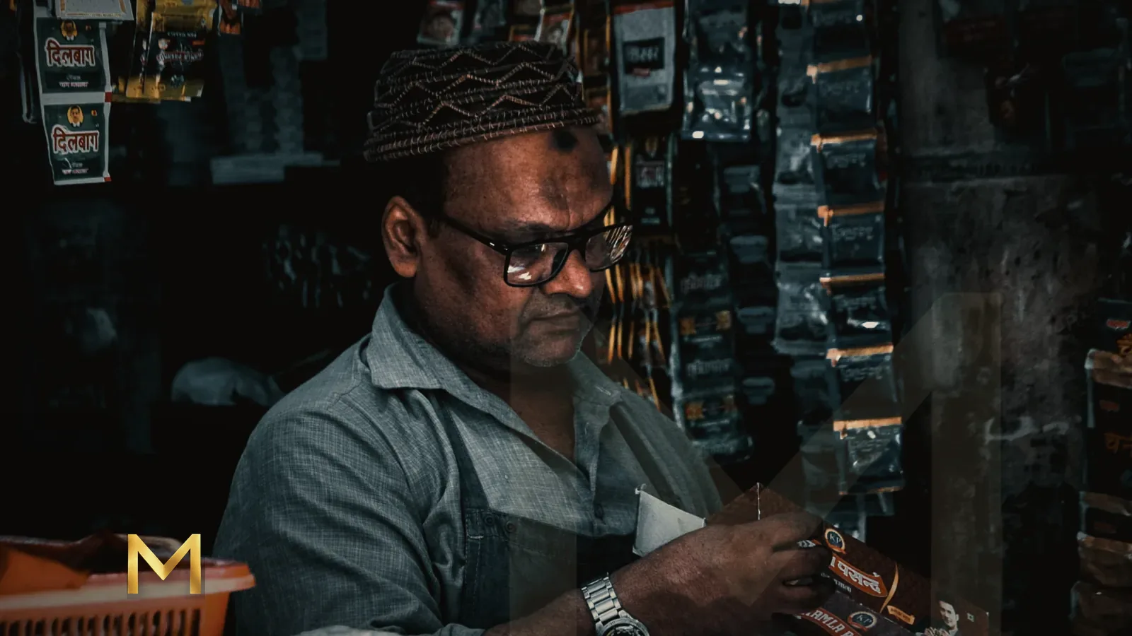 A shopkeeper at work among the crowded shelves of a small store